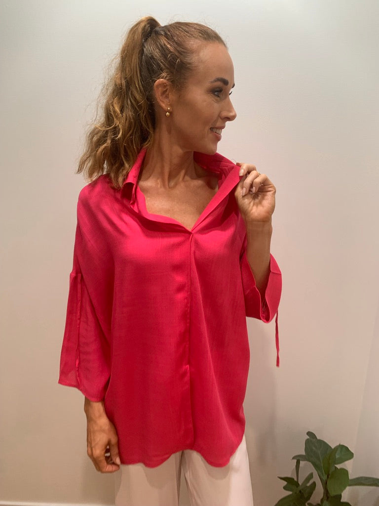 Lady in ultra pink blouse with 3/4 length sleeves