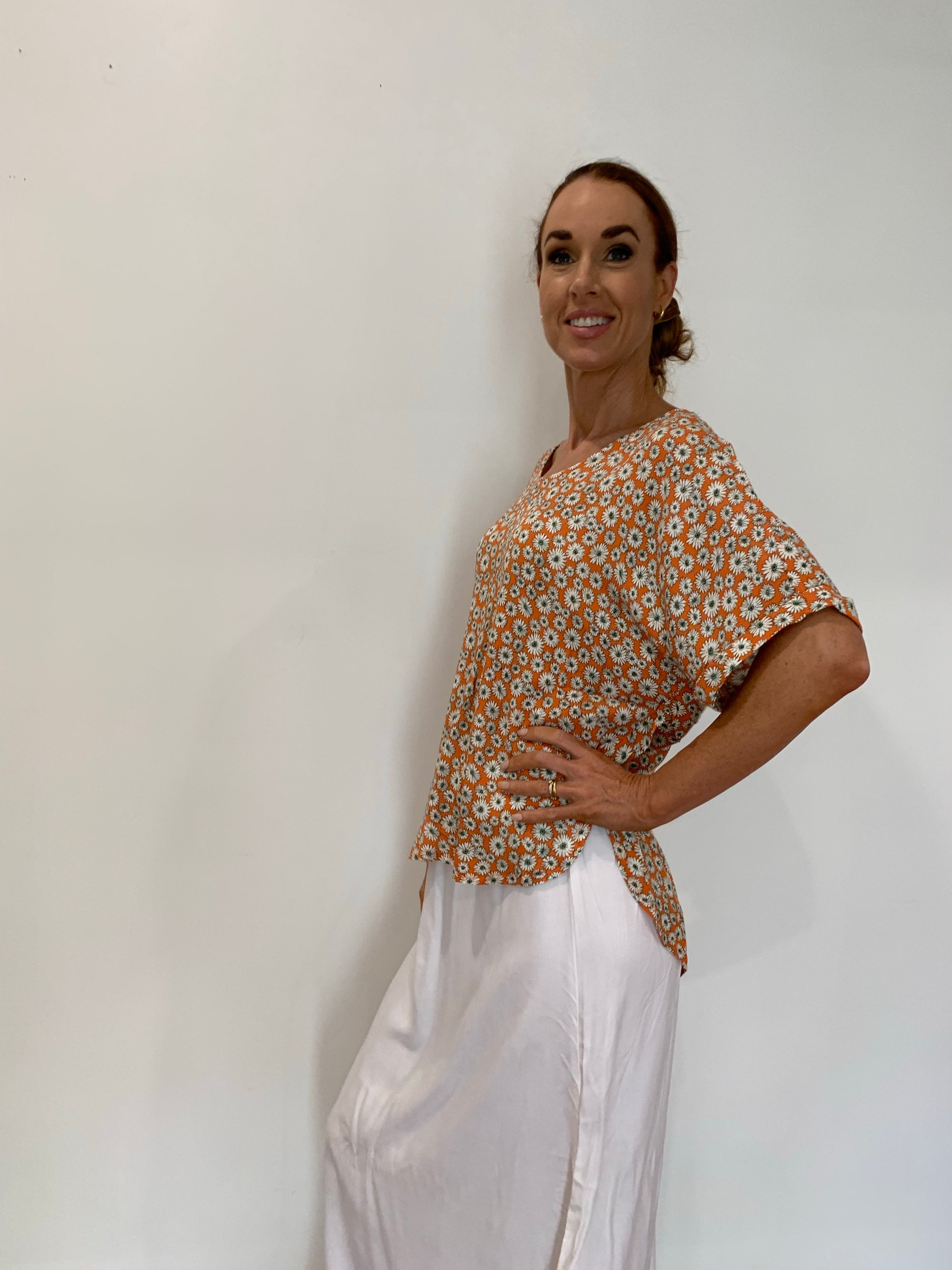 Orange Top with Daisy Print Short Cuffed Sleeves High Low Hemline - Silver Wishes